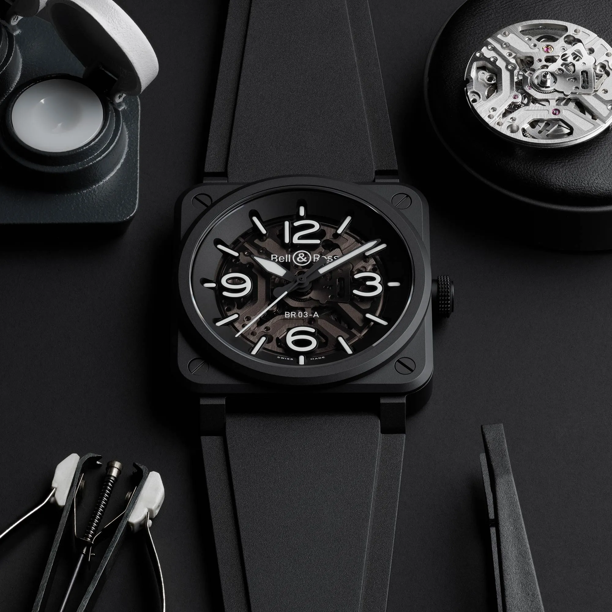 The Bell and Ross BR-03 Skeleton Black Ceramic next to its movement and manufacturing tools