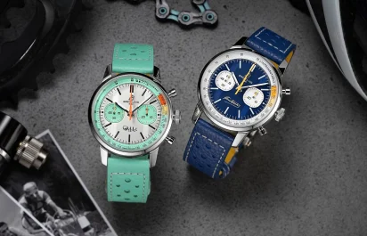 The limited-edition Breitling Top Time B01 Gino Bartali in blue and the Breitling Top Time B01 Fausto Coppi next to each other, surrounded by historic images and bike utensils.