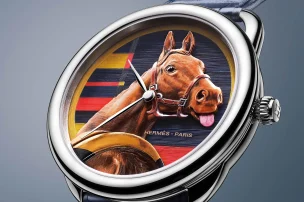 The Hermès Arceau Rocabar de Rire in front of a grey background.